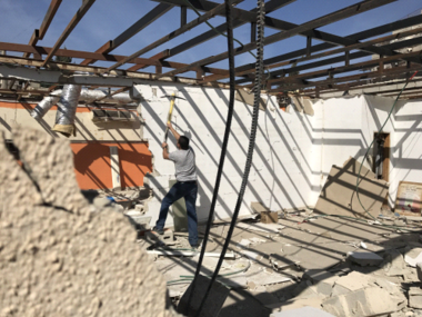 Zionist authorities force Palestinian citizen to demolish his house in Occupied al-Quds